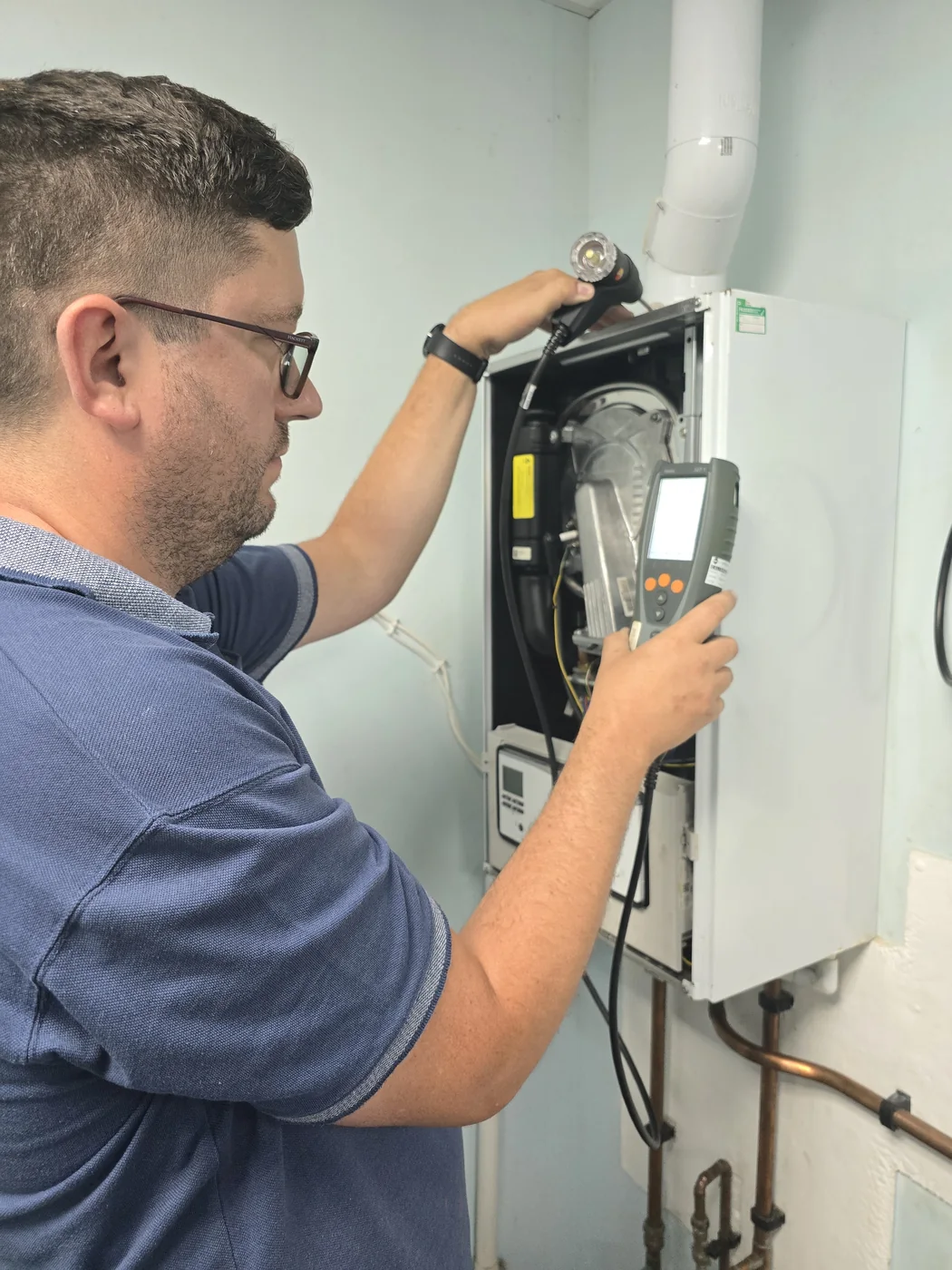 Rich Heating engineer carrying out boiler work